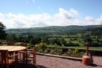 Our Bistro overlooks the valley encroached by an impressive escarpment and below the river Usk